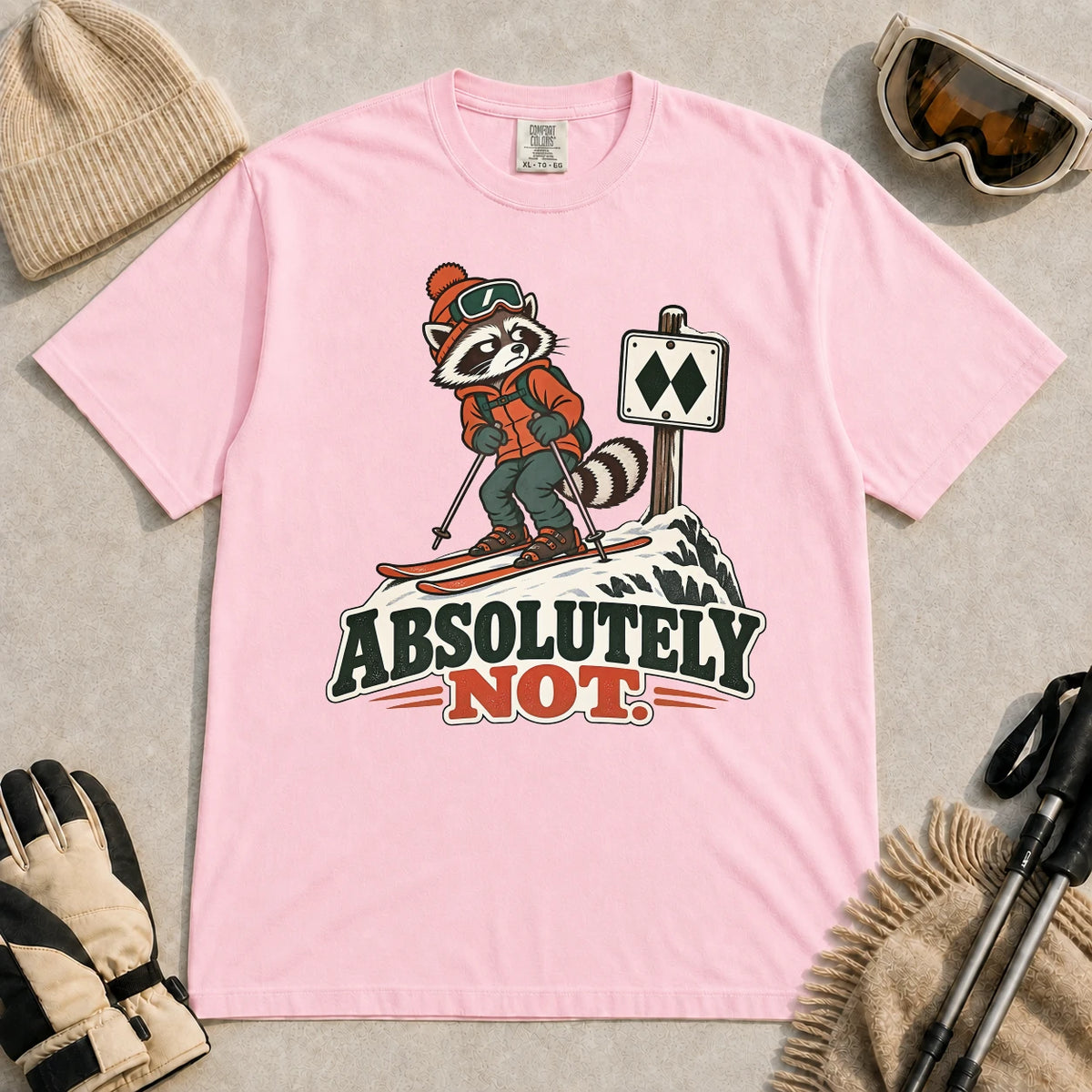 Blossom tee featuring a wary raccoon skier beside a double black diamond trail sign above the phrase “Absolutely Not.”