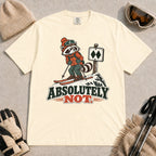 Ivory tee featuring a wary raccoon skier beside a double black diamond trail sign above the phrase “Absolutely Not.”