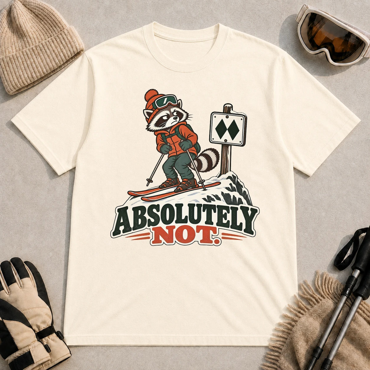 Natural tee featuring a wary raccoon skier beside a double black diamond trail sign above the phrase “Absolutely Not.”