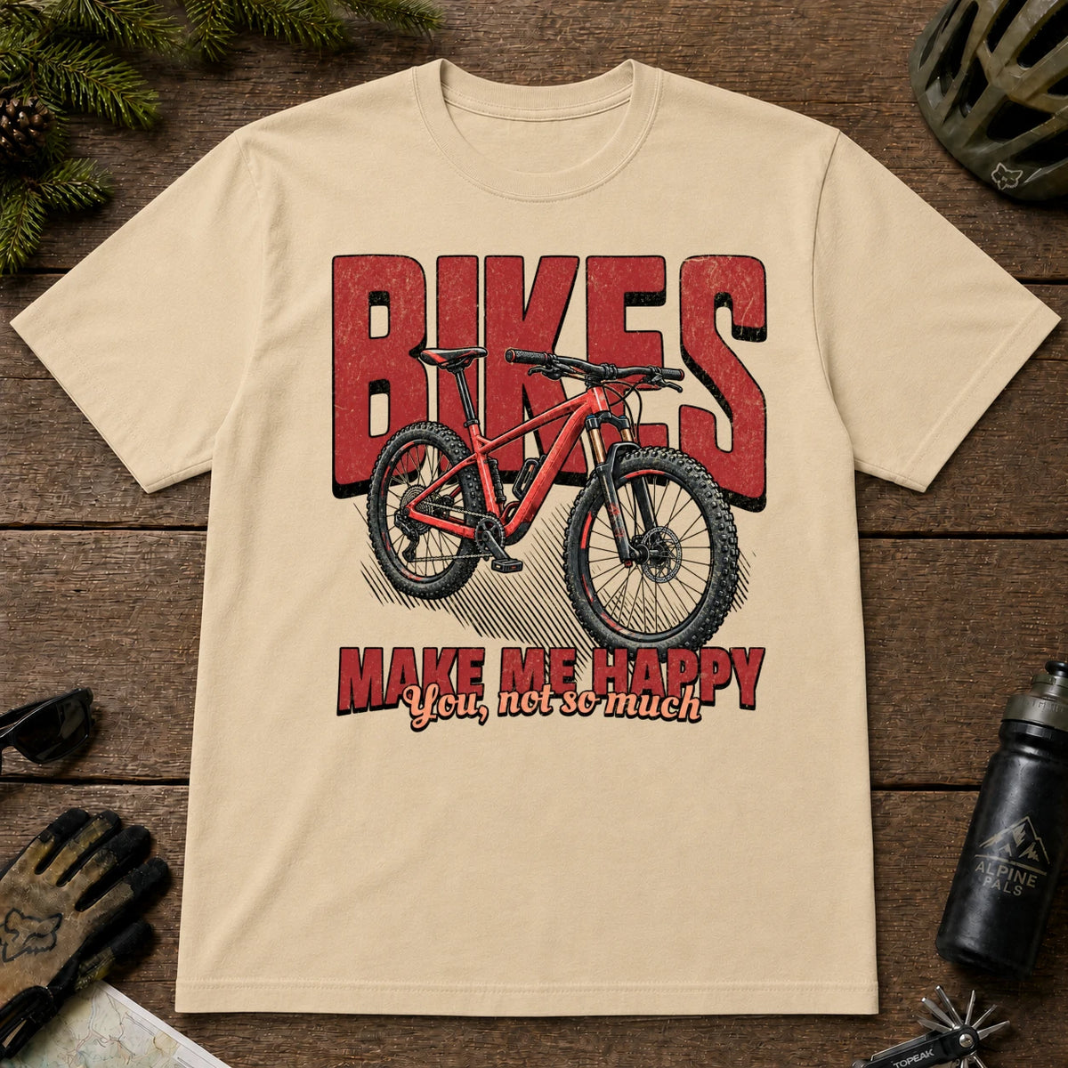 Sand tee featuring a red mountain bike in front of bold retro “Bikes” lettering with the phrase “Make Me Happy, You Not So Much.”