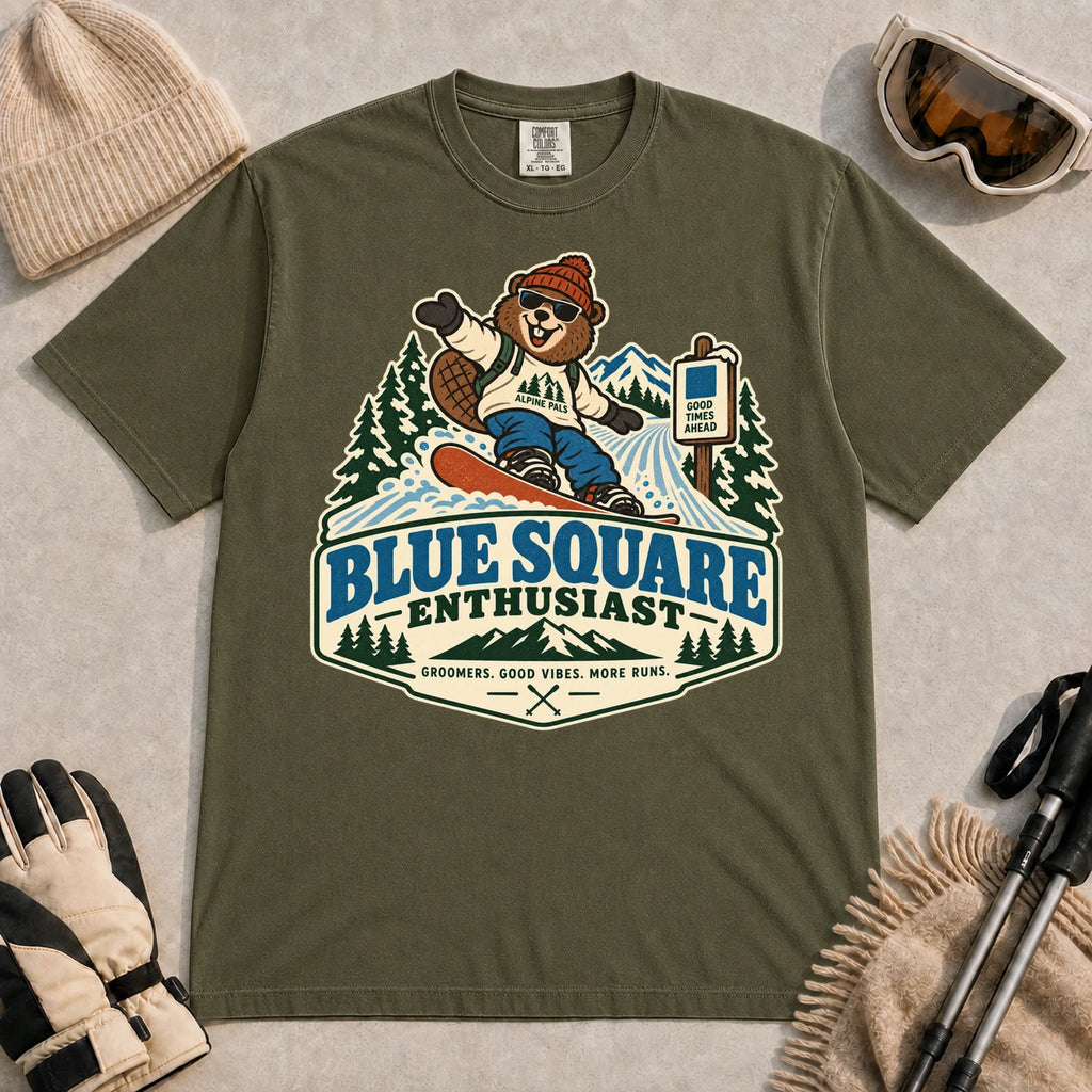 Hemp tee featuring a cheerful bear snowboarding past a blue-square trail sign above the phrase “Blue Square Enthusiast” with “Groomers. Good Vibes. More Runs.”