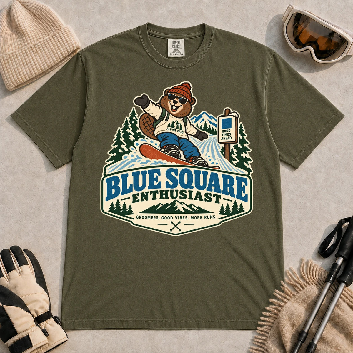 Hemp tee featuring a cheerful bear snowboarding past a blue-square trail sign above the phrase “Blue Square Enthusiast” with “Groomers. Good Vibes. More Runs.”