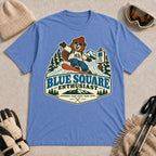 Heather Royal tee featuring a cheerful bear snowboarding past a blue-square trail sign above the phrase “Blue Square Enthusiast” with “Groomers. Good Vibes. More Runs.”