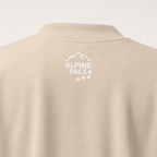 Sand colored sweater with 'Alpine Pals' logo on a white background