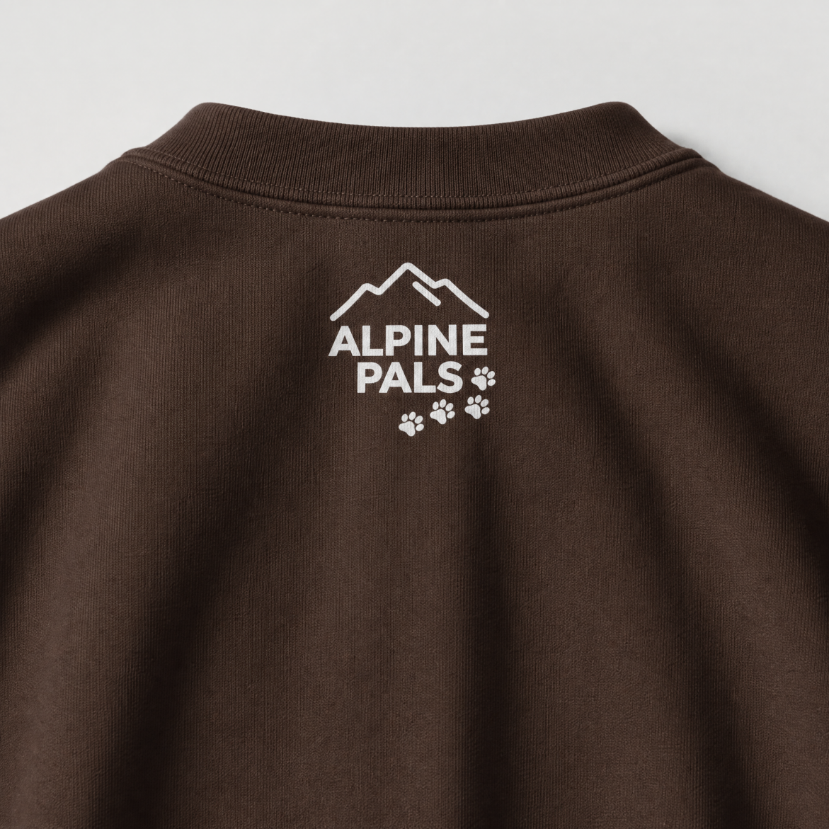 Dark chocolate brown sweatshirt with 'Alpine Pals' logo on a light gray background