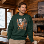 Man wearing a forest green sweatshirt with a graphic design in a cozy cabin setting
