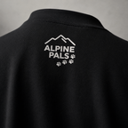 Black sweater with 'Alpine Pals' logo on the back against a gray background