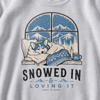 Sport gray sweatshirt with a graphic of a dog by a window with mountains, text 'Snowed In & Loving It', and a mug of hot chocolate.