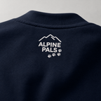 Navy blue sweater with 'Alpine Pals' logo on a gray background