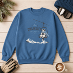 Indigo blue sweatshirt with a graphic design on a wooden surface with winter accessories.