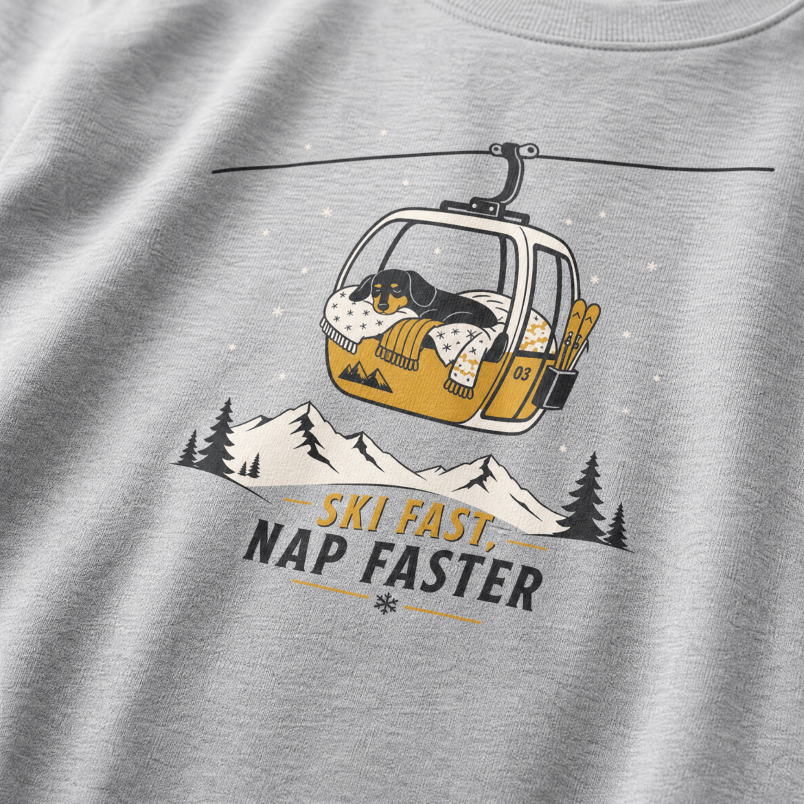 Sport gray t-shirt with a graphic of a dog in a ski lift and 'Ski Fast, Nap Faster' text on a mountain background.