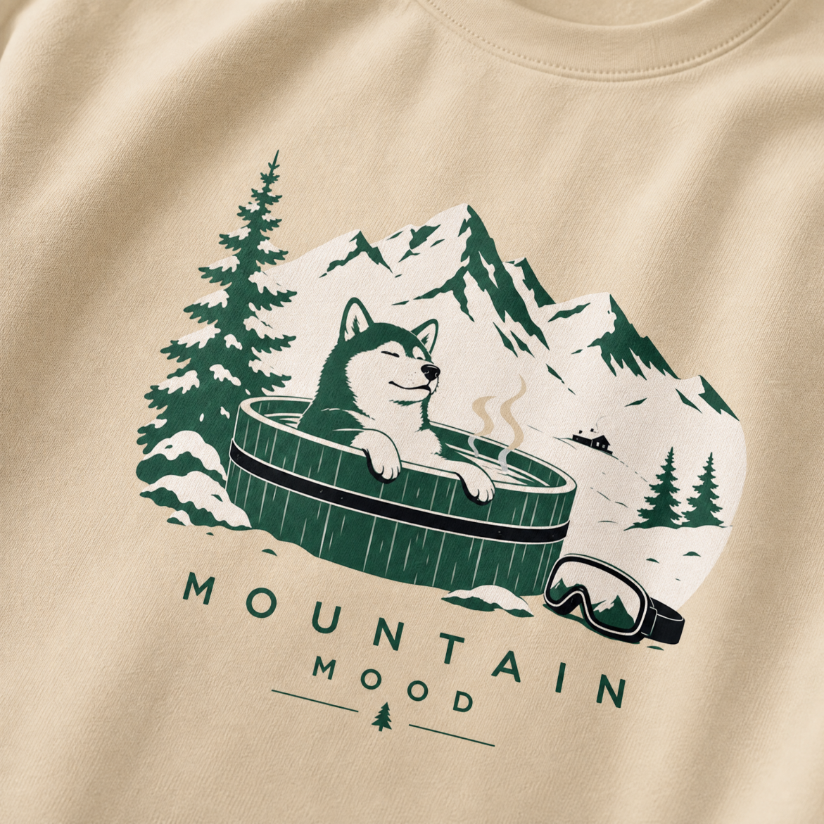 Sand colored sweatshirt with a graphic of a dog in a mountain scene and 'Mountain Mood' text.