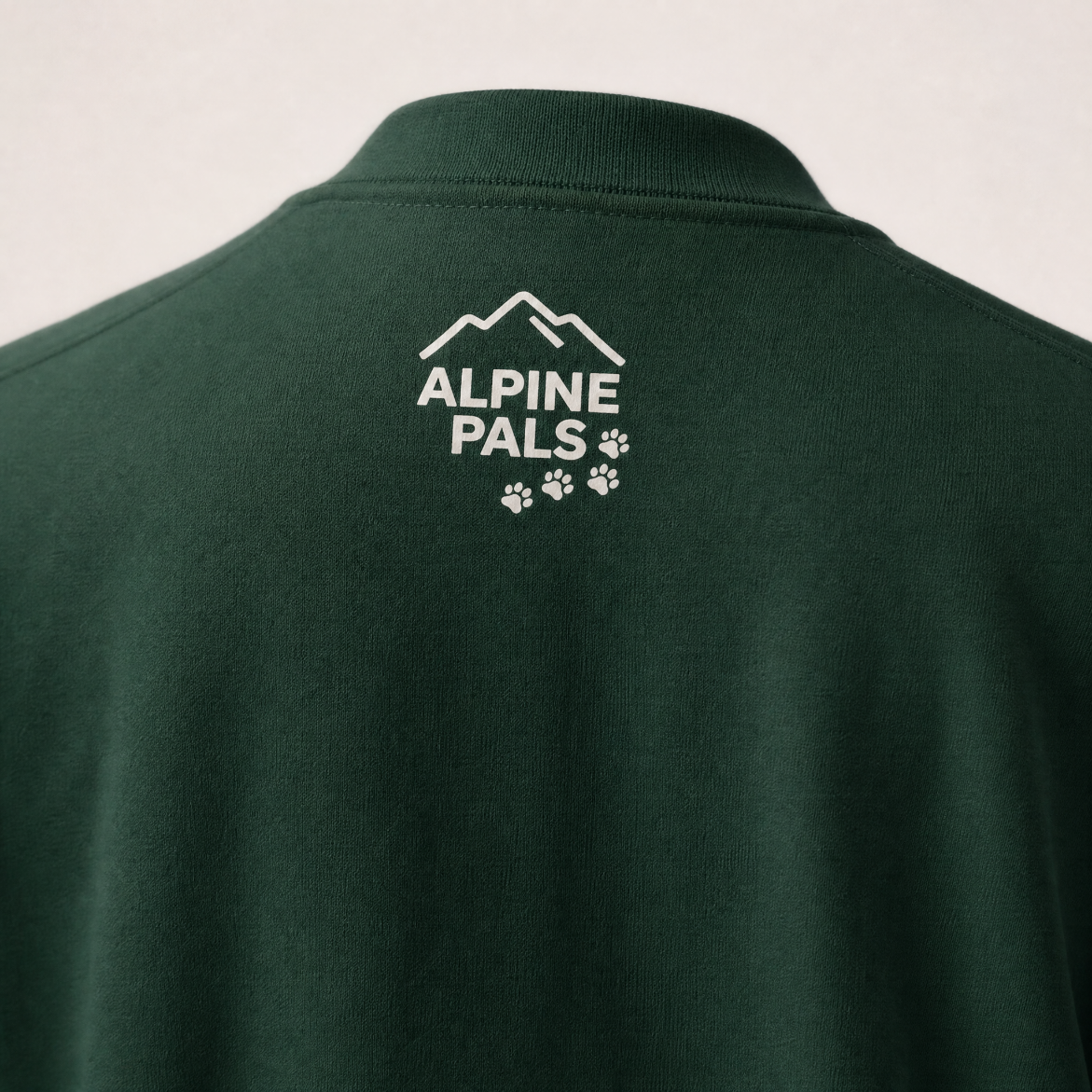 Forest green sweater with 'Alpine Pals' logo on the back