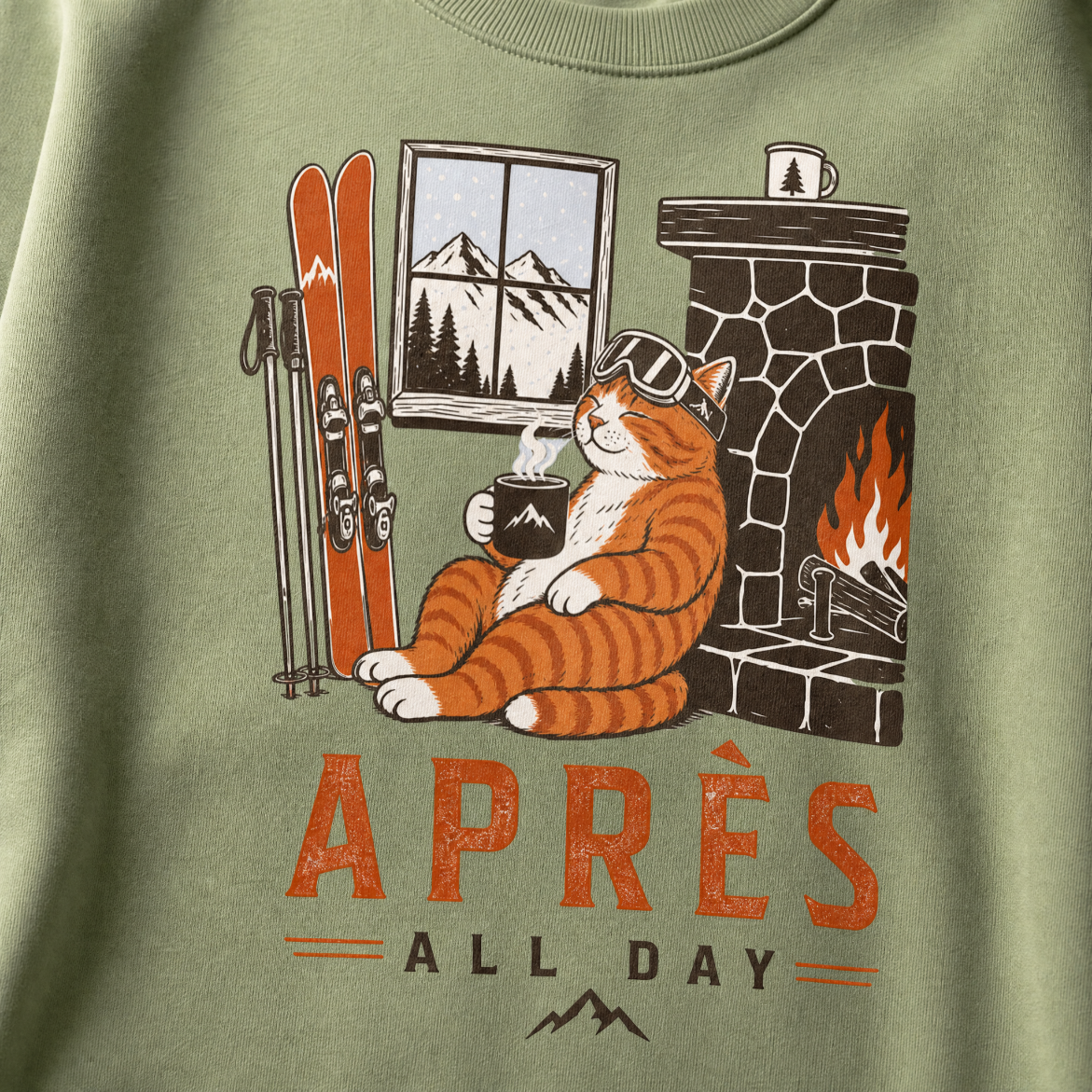 Military green sweatshirt with a cat graphic and 'Après All Day' text on a mountain-themed design.