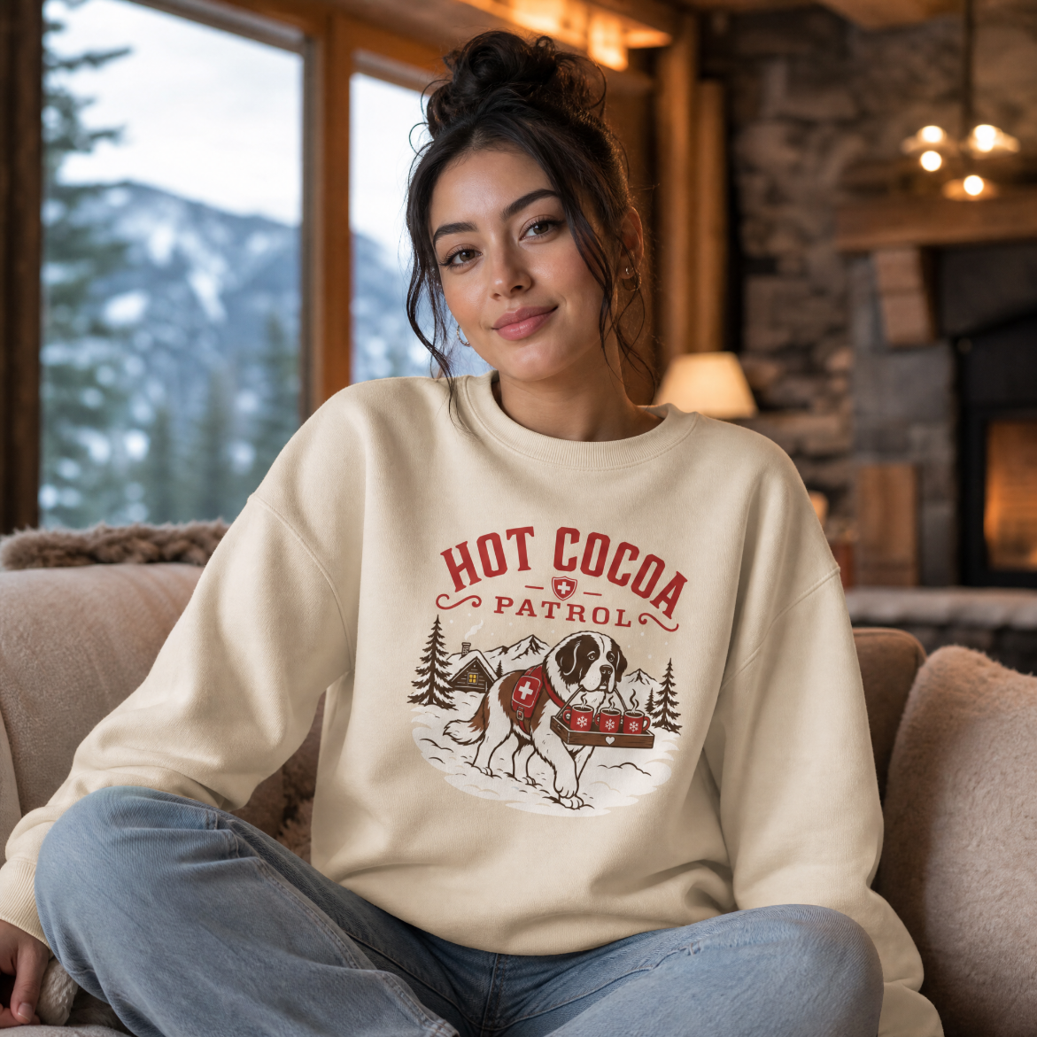 Woman wearing a 'Hot Cocoa Patrol' sweatshirt in a cozy living room with a fireplace and snowy landscape.