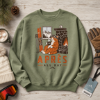 Military green sweatshirt with cat design and 'Apres All Day' text on a wooden surface with winter accessories.