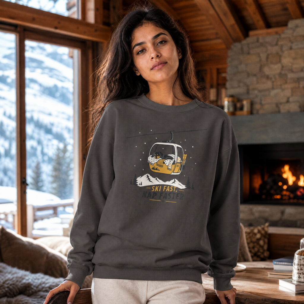 Woman wearing a charcoal gray sweatshirt with a graphic design in a cozy room with a fireplace and mountain view.