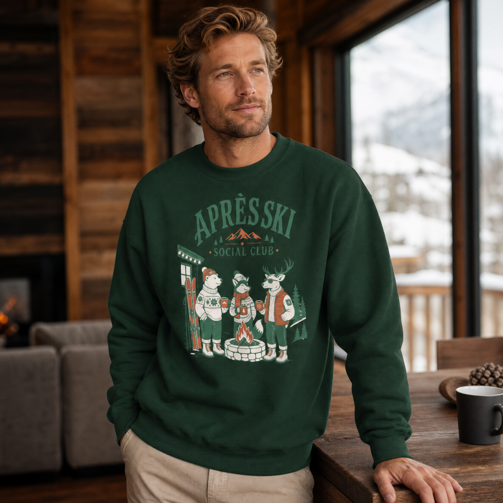 Man wearing a forest green sweatshirt with 'Après Ski Social Club' design in a cozy indoor setting.