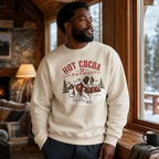 Man wearing a 'Hot Cocoa Patrol' sweatshirt in a cozy cabin setting.