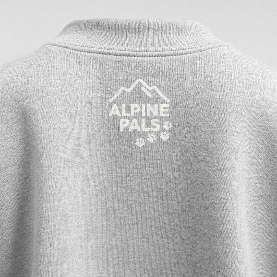 Ash gray sweater with 'Alpine Pals' logo on the back under the collar.