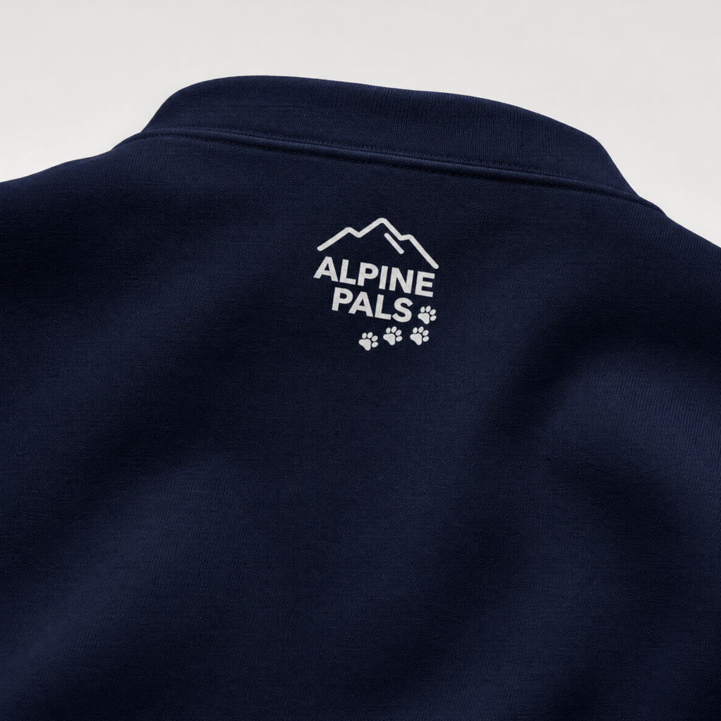 Navy blue sweater with 'Alpine Pals' logo on a light gray background