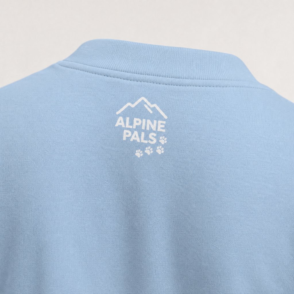 Light blue polo shirt with 'Alpine Pals' logo on the back against a light gray background