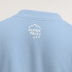 Light blue polo shirt with 'Alpine Pals' logo on the back against a light gray background