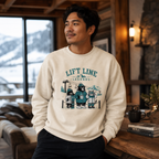 Man wearing a 'Lift Line Legends' sweater in a cozy indoor setting with a snowy outdoor view.
