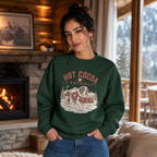 Woman wearing a forest green sweater with 'Hot Cocoa Patrol' text and a dog carrying 3 mugs printed on.