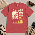 Crimson tee featuring a retro ski and mountain graphic with the phrase “Fresh Snow, Full Send.”