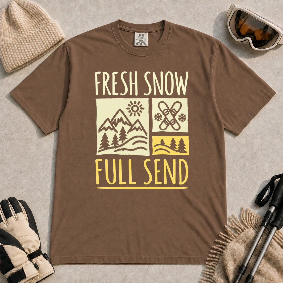 Espresso tee featuring a retro ski and mountain graphic with the phrase “Fresh Snow, Full Send.”