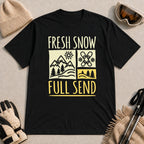 Black tee featuring a retro ski and mountain graphic with the phrase “Fresh Snow, Full Send.”