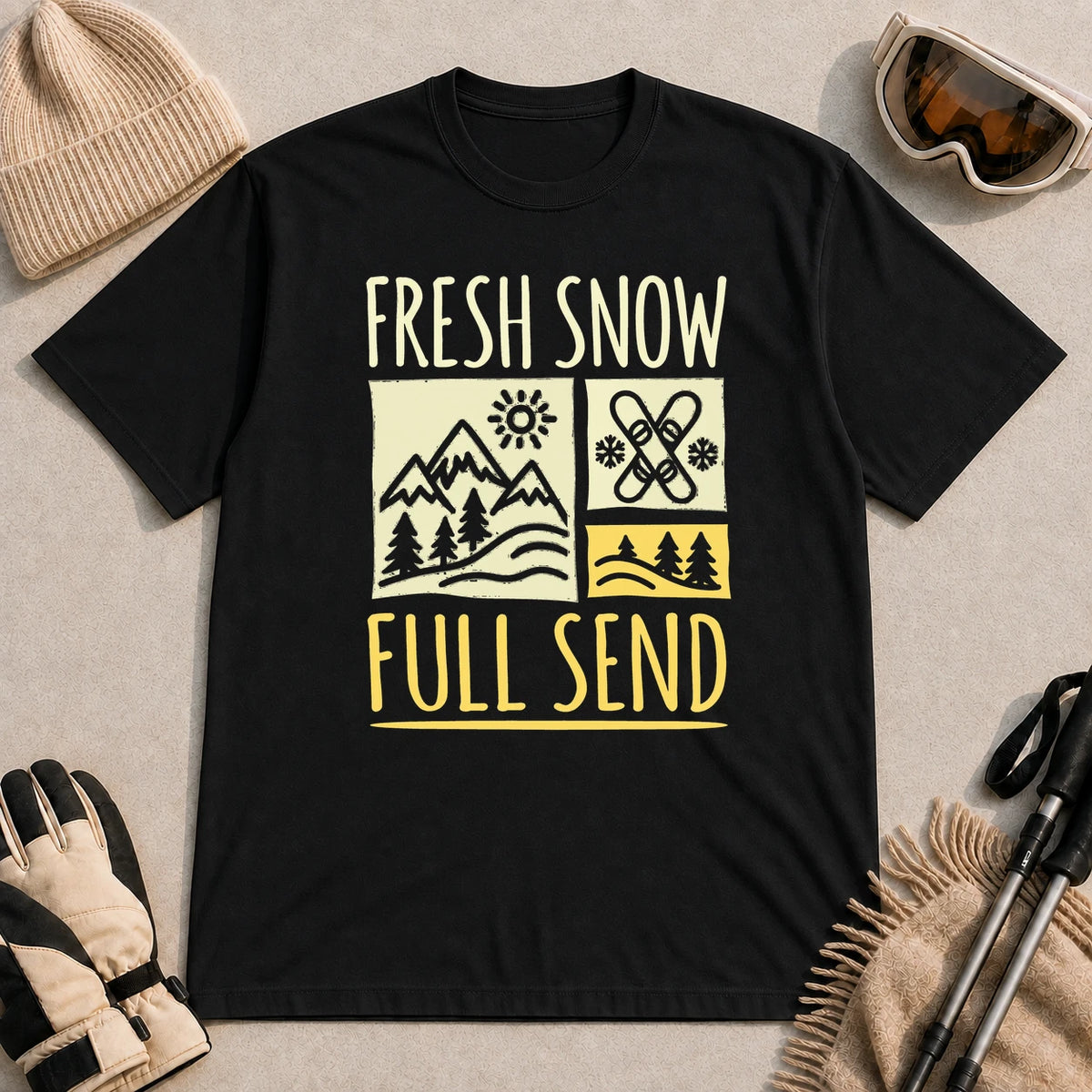 Black tee featuring a retro ski and mountain graphic with the phrase “Fresh Snow, Full Send.”