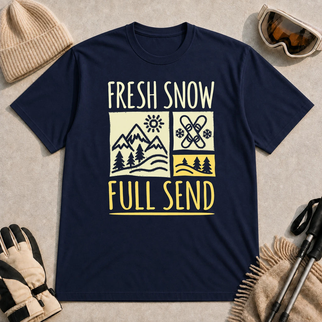 Navy tee featuring a retro ski and mountain graphic with the phrase “Fresh Snow, Full Send.”