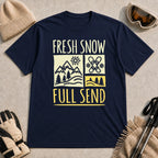 Navy tee featuring a retro ski and mountain graphic with the phrase “Fresh Snow, Full Send.”