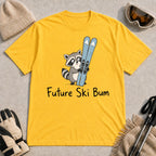 Daisy tee featuring a cute raccoon standing beside a pair of skis, with the phrase “Future Ski Bum.”
