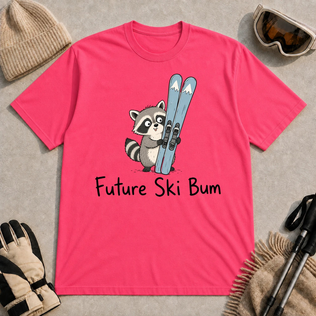 Heliconia tee featuring a cute raccoon standing beside a pair of skis, with the phrase “Future Ski Bum.”