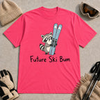 Heliconia tee featuring a cute raccoon standing beside a pair of skis, with the phrase “Future Ski Bum.”