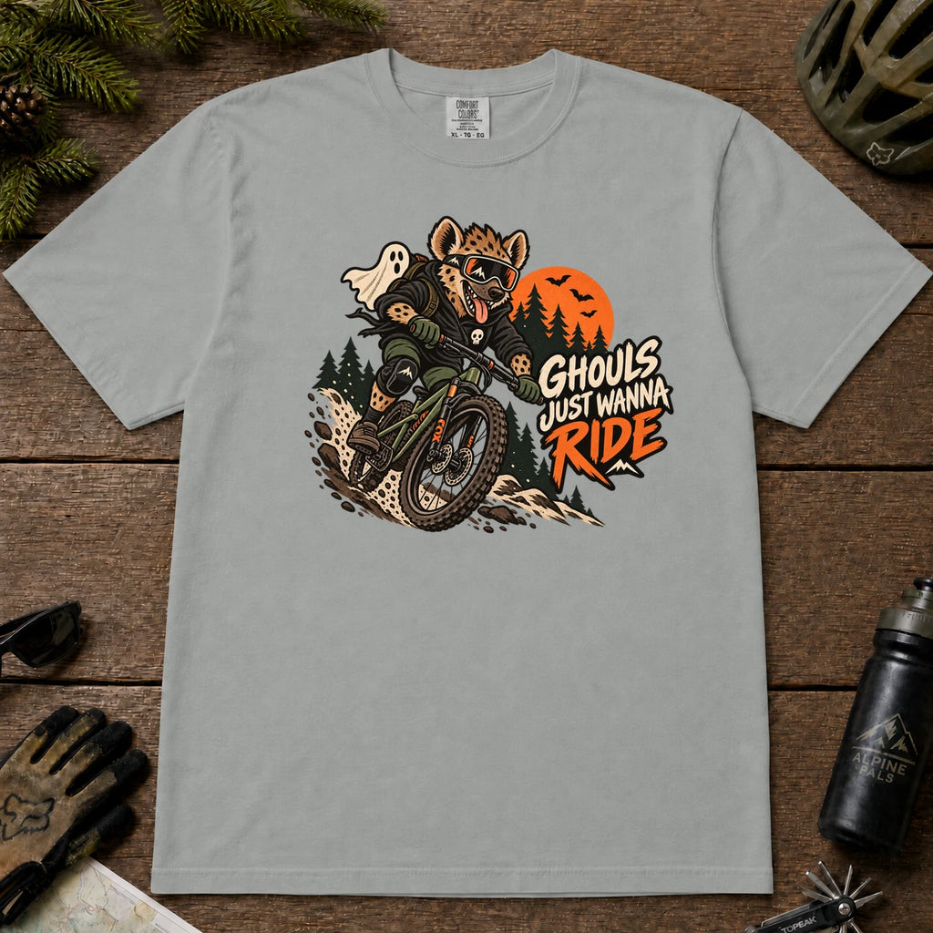 Granite tee featuring a hyena mountain biking through a spooky Halloween trail scene with a ghost, bats, and orange moon beside the phrase “Ghouls Just Wanna Ride.”