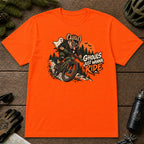 Orange tee featuring a hyena mountain biking through a spooky Halloween trail scene with a ghost, bats, and orange moon beside the phrase “Ghouls Just Wanna Ride.”
