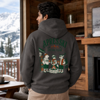 Person wearing a hoodie with 'Apres Ski Social Club' design in a cozy room with a snowy mountain view.