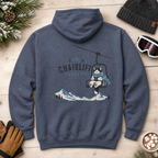 Heather sport dark navy hoodie with 'Chairlift Therapy' graphic on a wooden surface with winter accessories.