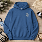 Indigo blue hoodie with 'Alpine Pals' logo on a wooden surface with winter accessories.