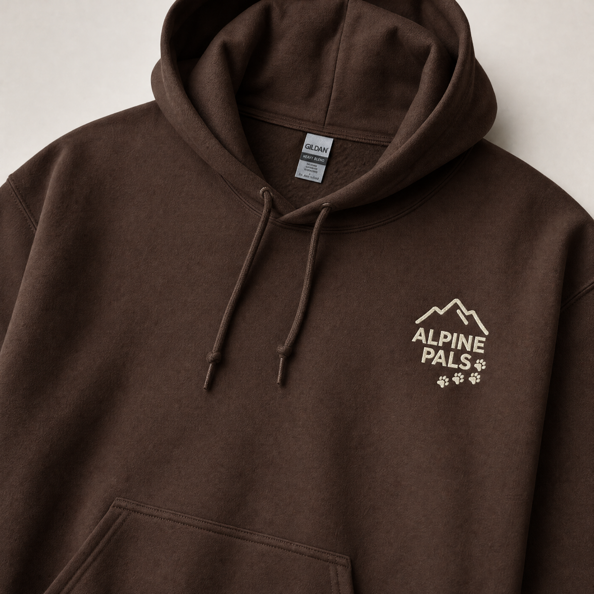 Dark chocolate brown hoodie with 'Alpine Pals' logo on a light gray background
