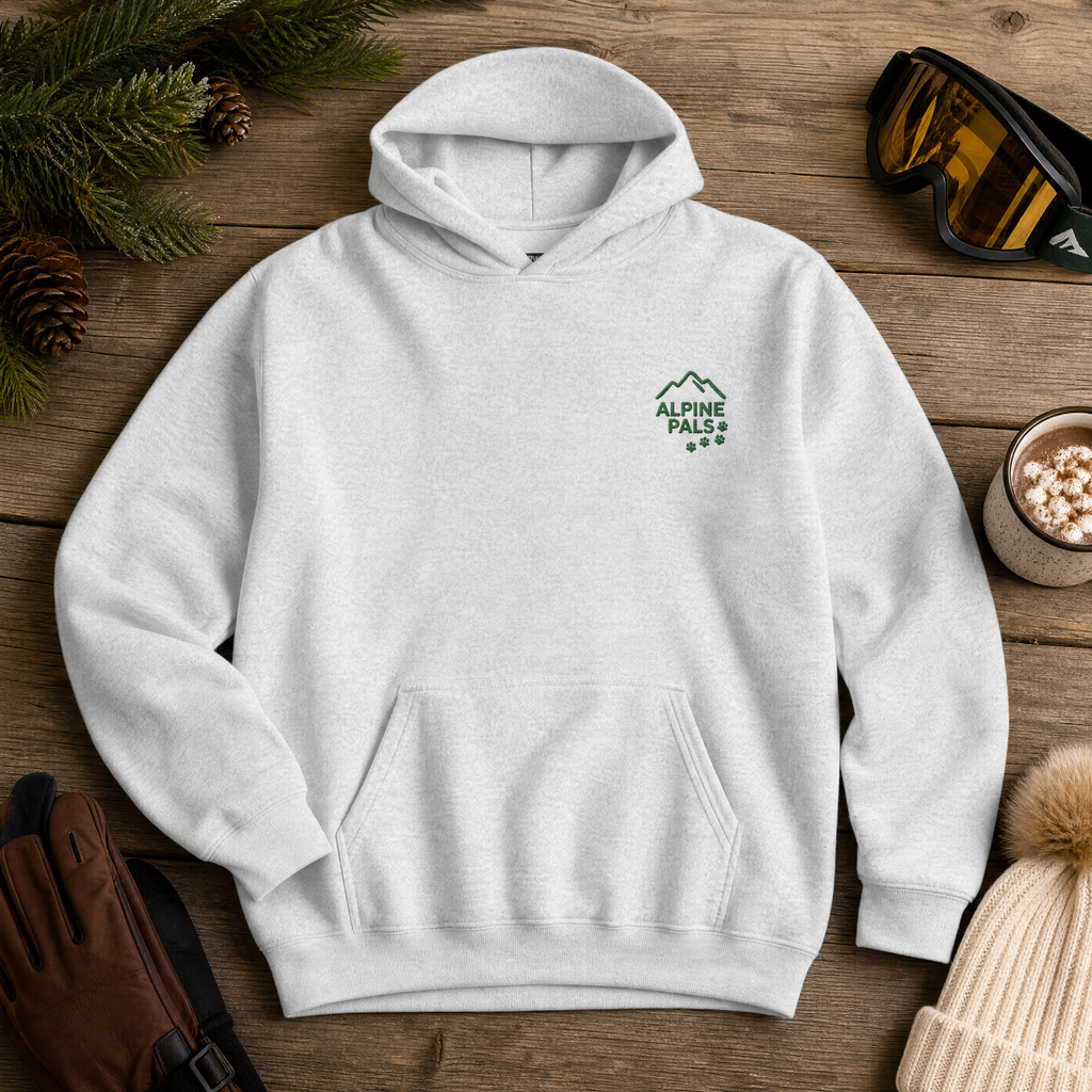 Ash gray hoodie with 'Alpine Pals' logo on a wooden surface with winter accessories.