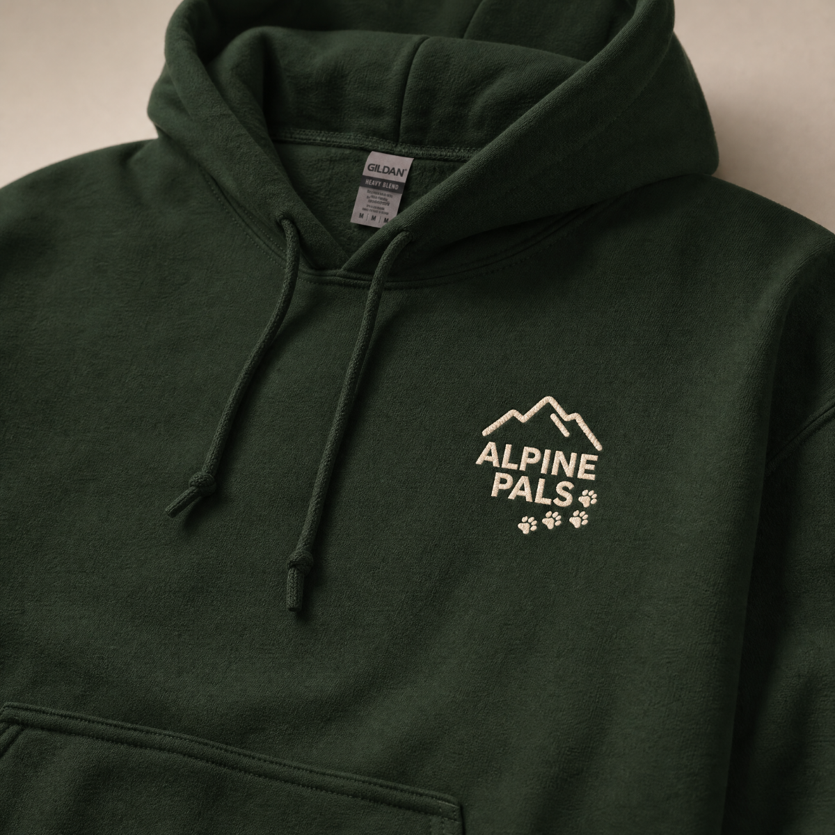 Forest green hoodie with 'Alpine Pals' logo on a neutral background