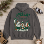 Charcoal gray hoodie with 'Après Ski Social Club' design on a wooden surface with winter accessories.