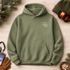Green hoodie with 'Alpine Pals' logo on a wooden surface with winter accessories.
