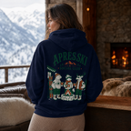 Person wearing a hoodie with 'Apres Ski Social Club' design in a cozy room with a fireplace and mountain view.