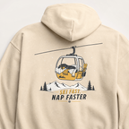 Sand colored hoodie with a graphic of a gondola and dog, and text 'Ski Fast, Nap Faster' on the back.